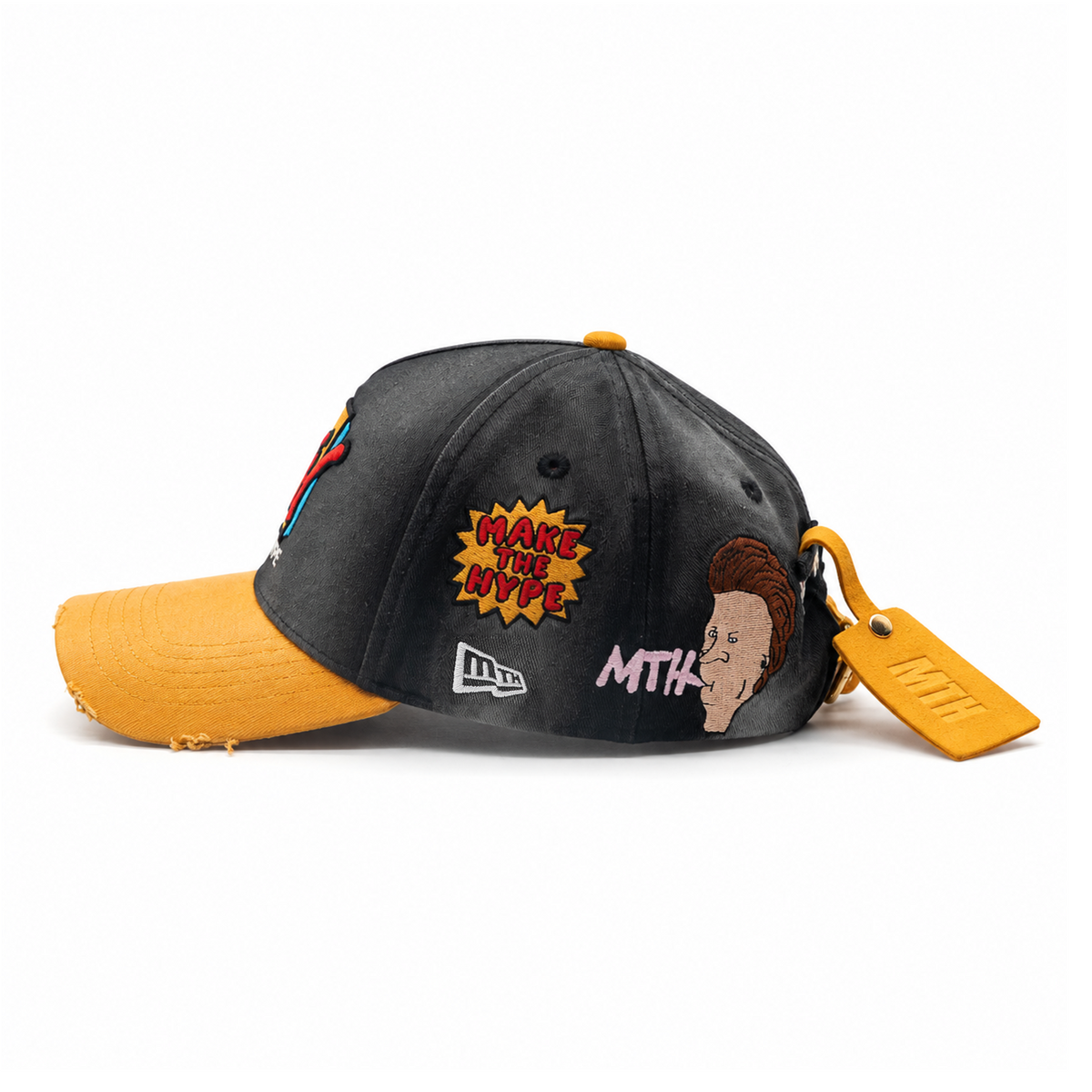 Cartoon-side profile of MAKE THE HYPE TV showing original MTH flag embroidery, distressed yellow brim and suede back tag